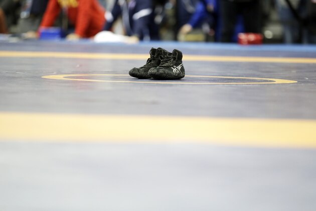 Spenser Mango's shoes sit on the center of the mat after losing to Jesse Thielke in their 59-kilogram Greco Roman match at the U.S. Olympic Wrestling Team Trials, Saturday, April 9, 2016, in Iowa City, Iowa. (AP Photo/Charlie Neibergall)