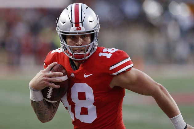 FILE - In this Sept. 22, 2018, file photo, Ohio State quarterback Tate Martell runs against Tulane during an NCAA college football game in Columbus, Ohio. Martell says he is transferring from Ohio State to Miami. Martell announced on Twitter early Wednesday, Jan. 16: “I’m a Hurricane.” Martell had entered his name into the NCAA transfer portal last week and was free to be approached by schools about a potential transfer. (AP Photo/Jay LaPrete, File)