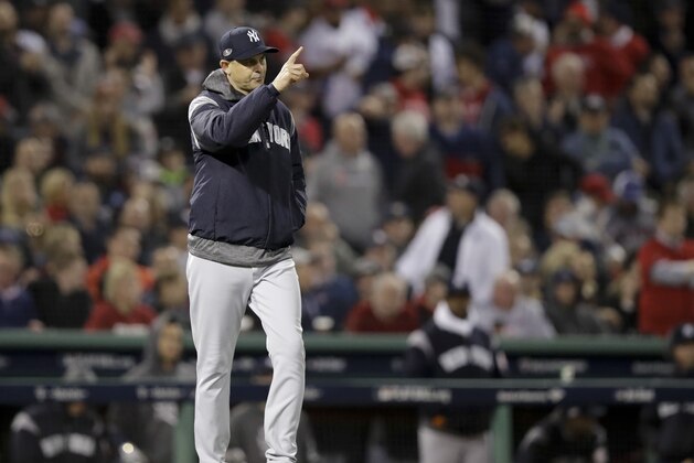 New York Yankees manager Aaron Boone calls for a new pitcher during the third inning of Game 1 of a baseball American League Division Series against the Boston Red Sox on Friday, Oct. 5, 2018, in Boston. (AP Photo/Charles Krupa)