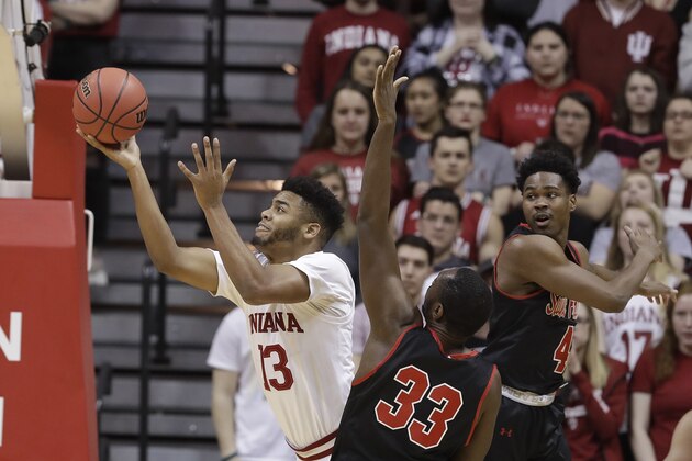 Indiana's Juwan Morgan (13) puts up a shot against Saint Francis's Luidgy Laporal (33) and Randall Gaskins Jr. (4) during the first half of an NCAA college basketball game in the first round of the NIT tournament, Tuesday, March 19, 2019, in Bloomington, Ind. (AP Photo/Darron Cummings)