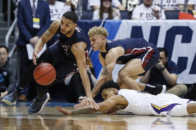 Fairleigh Dickinson's Darnell Edge, left, scrambles after a loose ball against Prairie View A&M's Dennis Jones, bottom right, during the first half of a First Four game of the NCAA college basketball tournament, Tuesday, March 19, 2019, in Dayton, Ohio. (AP Photo/John Minchillo)