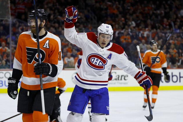 Montreal Canadiens' Brendan Gallagher, center, celebrates past Philadelphia Flyers' Sean Couturier, left, after scoring a goal during the first period of an NHL hockey game, Tuesday, March 19, 2019, in Philadelphia. (AP Photo/Matt Slocum)