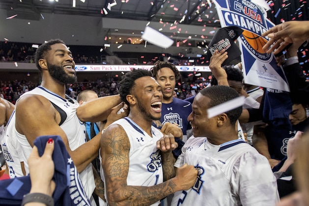 Old Dominion's Ahmad Caver, center, Justice Kithcart (2) and Elbert Robinson III, left, celebrate after Old Dominion defeated Western Kentucky 62-56 in an NCAA college basketball game for the Conference USA men's tournament championship Saturday, March 16, 2019, in Frisco, Texas. (AP Photo/Jeffrey McWhorter)