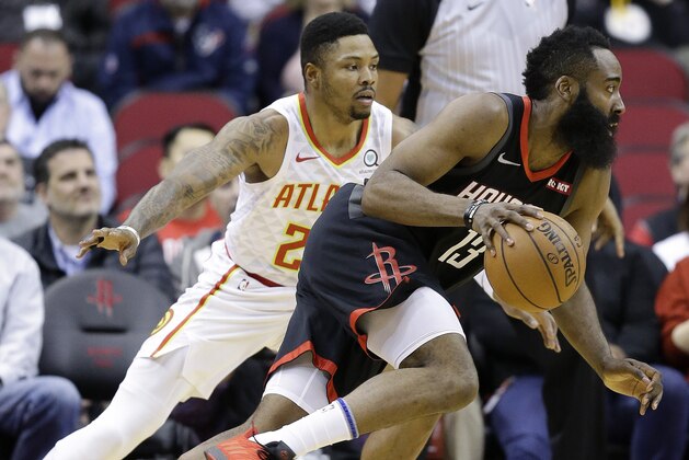 CORRECTS YEAR TO 2019 NOT 2018 - Houston Rockets guard James Harden, right, drives past Atlanta Hawks guard Kent Bazemore during the first half of an NBA basketball game, Monday, Feb. 25, 2019, in Houston. (AP Photo/Eric Christian Smith)