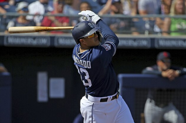 FILE - In this Monday, March 4, 2019, file photo, San Diego Padres' Manny Machado hits a pop fly against the Cleveland Indians during the first inning of a spring training baseball game in Peoria, Ariz. Manny Mania touches down in San Diego this season, where the signing of slugger Manny Machado has led to increased ticket sales for the Padres and inspired at least two craft beers (AP Photo/Ross D. Franklin, File)
