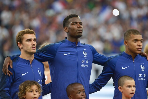 PARIS, FRANCE - SEPTEMBER 09: Antoine Griezmann (L), Paul Pogba (C),  Kylian Mbappe (R), of France looks on during the national anthem during the UEFA Nations League A group official match between France and Netherlands at Stade de France on September 9, 2018 in Paris, France. This is the first match of the French football team at the Stade de France since their victory in the final of the World Cup in Russia.  (Photo by Frederic Stevens/Getty Images)