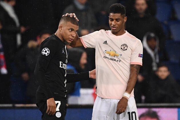 Manchester United's English forward Marcus Rashford (R) cheers up Paris Saint-Germain's French forward Kylian Mbappe at the end of the UEFA Champions League round of 16 second-leg football match between Paris Saint-Germain (PSG) and Manchester United at the Parc des Princes stadium in Paris on March 6, 2019. (Photo by FRANCK FIFE / AFP)        (Photo credit should read FRANCK FIFE/AFP/Getty Images)
