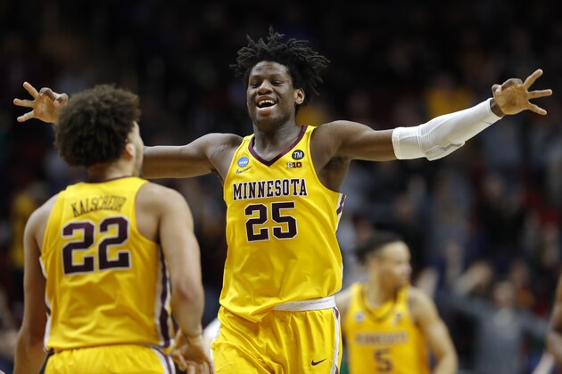 Minnesota center Daniel Oturu (25) celebrates with teammate Gabe Kalscheur (22) during a first round men's college basketball game against Louisville in the NCAA Tournament, Thursday, March 21, 2019, in Des Moines, Iowa. (AP Photo/Charlie Neibergall)