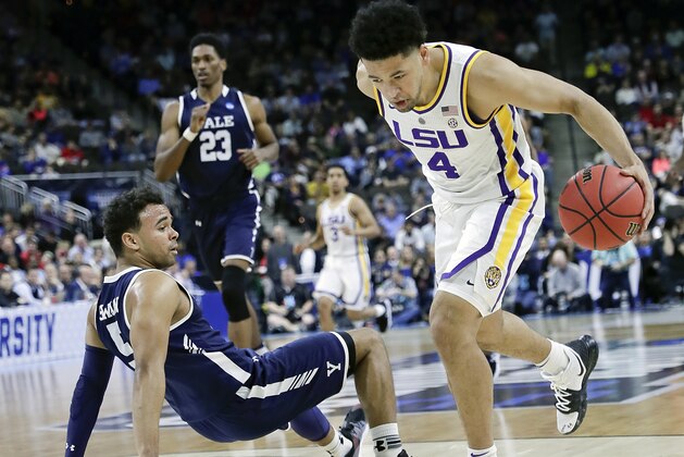 Yale 's Azar Swain, left, falls backward as LSU's Skylar Mays (4) drives past him to the basket during the first half of a first round men's college basketball game in the NCAA Tournament in Jacksonville, Fla., Thursday, March 21, 2019. (AP Photo/John Raoux)