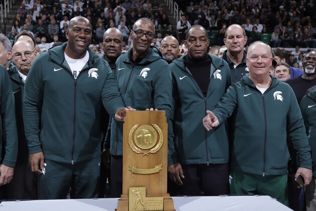 Former players on Michigan State's 1979 national championship team, including Magic Johnson, front row from left, Greg Kelser, Ron Charles and Terry Donnelly are honored at halftime of an NCAA college basketball game between Minnesota and Michigan State, Saturday, Feb. 9, 2019, in East Lansing, Mich. Michigan State won 79-55. (AP Photo/Al Goldis)