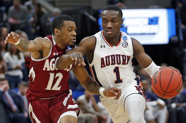 Auburn Tigers guard Jared Harper (1) drives as New Mexico State guard AJ Harris (12) defends in the first half during a first round men's college basketball game in the NCAA Tournament, Thursday, March 21, 2019, in Salt Lake City. (AP Photo/Rick Bowmer)