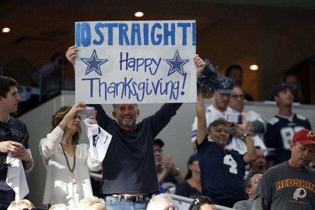 A against the Dallas Cowboys fan holds up a sign making a reference to th Thanksgiving holiday during an NFL football game against the Washington Redskins on Thursday, Nov. 24, 2016, in Arlington, Texas. (AP Photo/Michael Ainsworth)