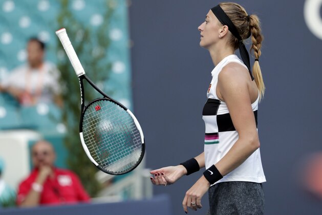 Petra Kvitova, of the Czech Republic, tosses her racket during her match against Maria Sakkari, of Greece, during the Miami Open tennis tournament, Thursday, March 21, 2019, in Miami Gardens, Fla. (AP Photo/Lynne Sladky)