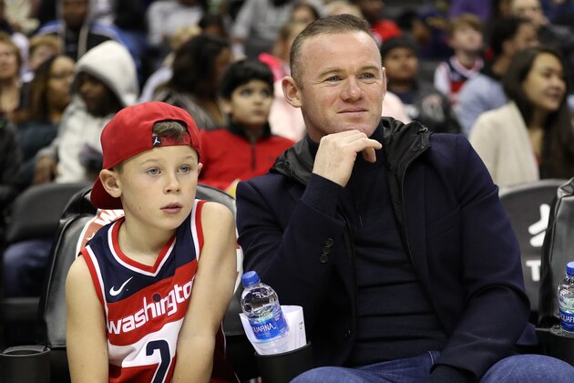 WASHINGTON, DC - DECEMBER 01:  DC United soccer player, and former Manchester United player, Wayne Rooney looks on from a court side seat with his son as the Brooklyn Nets play the Washington Wizards during the first half at Capital One Arena on December 01, 2018 in Washington, DC. NOTE TO USER: User expressly acknowledges and agrees that, by downloading and or using this photograph, User is consenting to the terms and conditions of the Getty Images License Agreement. (Photo by Patrick Smith/Getty Images)
