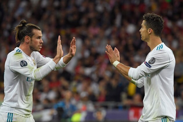 Real Madrid's Welsh forward Gareth Bale (L) celebrates with Real Madrid's Portuguese forward Cristiano Ronaldo during the UEFA Champions League final football match between Liverpool and Real Madrid at the Olympic Stadium in  Kiev, Ukraine on May 26, 2018. (Photo by LLUIS GENE / AFP)        (Photo credit should read LLUIS GENE/AFP/Getty Images)