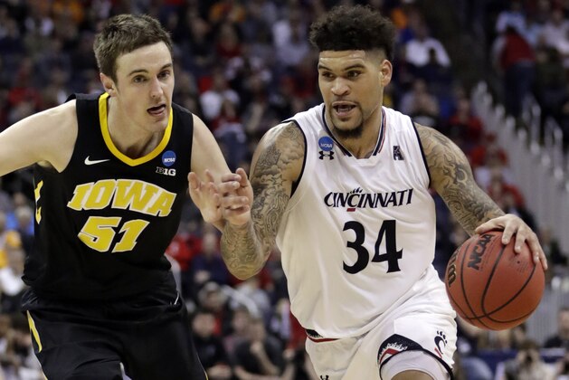 Cincinnati's Jarron Cumberland (34) drives past Iowa's Nicholas Baer (51) in the first half during a first round men's college basketball game in the NCAA Tournament in Columbus, Ohio, Friday, March 22, 2019. (AP Photo/Tony Dejak)