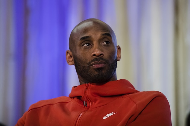Former Los Angeles Lakers NBA basketball player Kobe Bryant listens to a question as he meets with students at Andrew Hamilton School in Philadelphia, Thursday, March 21, 2019. Kobe Bryant was promoting the book The Wizenard Series: Training Camp he created with writer Wesley King. (AP Photo/Matt Rourke)