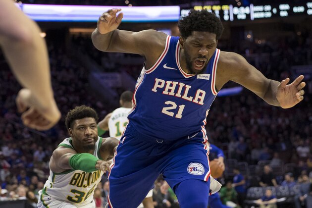 PHILADELPHIA, PA - MARCH 20: Marcus Smart #36 of the Boston Celtics pushes Joel Embiid #21 of the Philadelphia 76ers to the ground in the third quarter at the Wells Fargo Center on March 20, 2019 in Philadelphia, Pennsylvania. The 76ers defeated the Celtics 118-115. NOTE TO USER: User expressly acknowledges and agrees that, by downloading and or using this photograph, User is consenting to the terms and conditions of the Getty Images License Agreement.(Photo by Mitchell Leff/Getty Images)