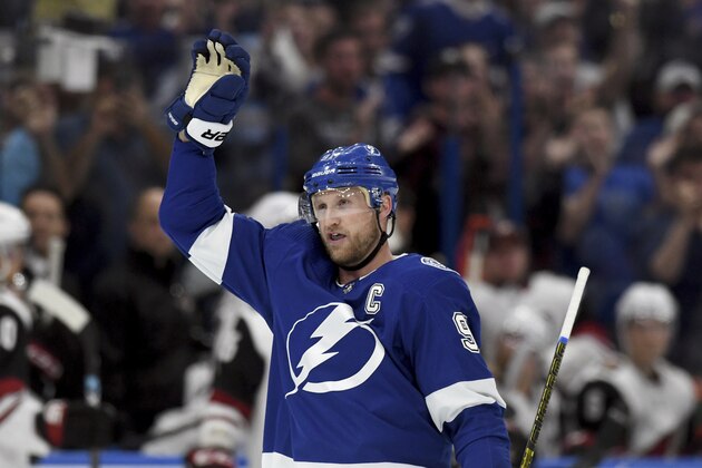 Tampa Bay Lightning center Steven Stamkos (91) waves to the crowd after becoming the all-time franchise goal leader (384) with his first-period goal during an NHL hockey game against the Arizona Coyotes, Monday, March 18, 2019, in Tampa, Fla. (AP Photo/Jason Behnken)