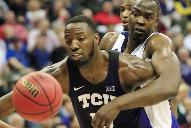 Kansas State forward Makol Mawien, right, reaches around TCU forward JD Miller, left, during the first half of an NCAA college basketball game in the quarterfinals of the Big 12 conference tournament in Kansas City, Mo., Thursday, March 14, 2019. (AP Photo/Orlin Wagner)