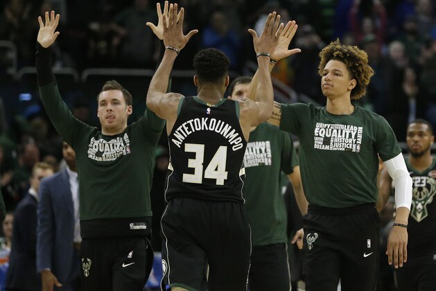 Milwaukee Bucks' Giannis Antetokounmpo (34) is congratulated by teammates after an NBA basketball game against the Boston Celtics Thursday, Feb. 21, 2019, in Milwaukee. The Bucks won 98-97. (AP Photo/Aaron Gash)