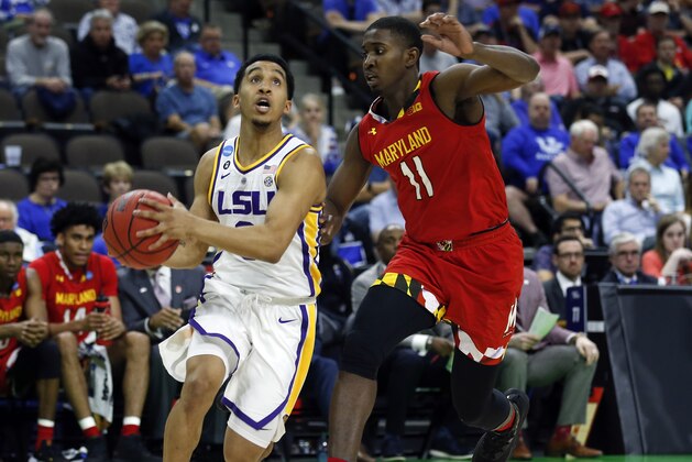 LSU's Tremont Waters, left, goes to the basket past Maryland's Darryl Morsell (11) during the first half of a second-round game in the NCAA men’s college basketball tournament in Jacksonville, Fla., Saturday, March 23, 2019. (AP Photo/Stephen B. Morton)
