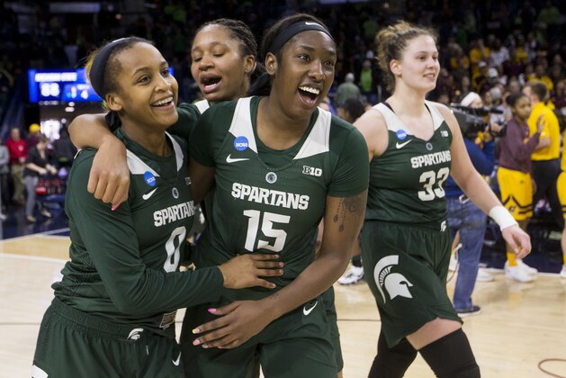 Michigan State's Shay Colley (0) and Victoria Gaines (15) hug as they walk off the court following their 88-87 win over Central Michigan in a first-round game in the NCAA women's college basketball tournament in South Bend, Ind., Saturday, March 23, 2019. (AP Photo/Robert Franklin)