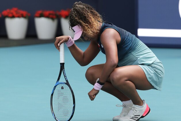 Naomi Osaka, of Japan, kneels on the court during her match against Hsieh Su-Wei, of Taiwan, during the Miami Open tennis tournament, Saturday, March 23, 2019, in Miami Gardens, Fla. (AP Photo/Lynne Sladky)