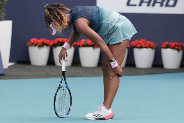 Naomi Osaka, of Japan, holds her leg during her match against Hsieh Su-Wei, of Taiwan, during the Miami Open tennis tournament, Saturday, March 23, 2019, in Miami Gardens, Fla. (AP Photo/Lynne Sladky)