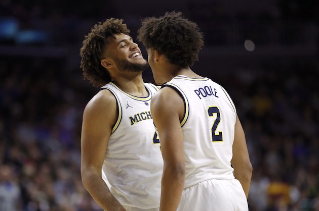 Michigan forward Isaiah Livers, left, celebrates with teammate Jordan Poole after making a basket during a second round men's college basketball game against Florida in the NCAA Tournament, Saturday, March 23, 2019, in Des Moines, Iowa. (AP Photo/Charlie Neibergall)