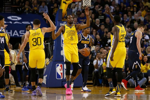OAKLAND, CA - MARCH 08: Kevin Durant #35 of the Golden State Warriors celebrates after a play with teammates Stephen Curry #30 and Draymond Green #23 after a play against the Denver Nuggets at ORACLE Arena on March 8, 2019 in Oakland, California. NOTE TO USER: User expressly acknowledges and agrees that, by downloading and or using this photograph, User is consenting to the terms and conditions of the Getty Images License Agreement. (Photo by Lachlan Cunningham/Getty Images)