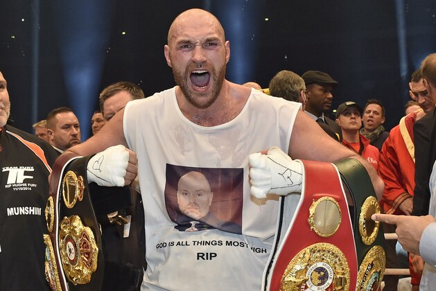 FILE - In this Nov. 29, 2015 file photo, Britain's new world champion Tyson Fury, celebrates with the WBA, IBF, WBO and IBO belts after winning the world heavyweight title fight against Ukraine's Wladimir Klitschko in Duesseldorf, western Germany. Tyson Fury's boxing career could be over after the reigning IBF, WBO and WBA heavyweight champion announced his retirement in a profanity-filled tweet on Monday Oct. 3, 2016. (AP Photo/Martin Meissner, File)