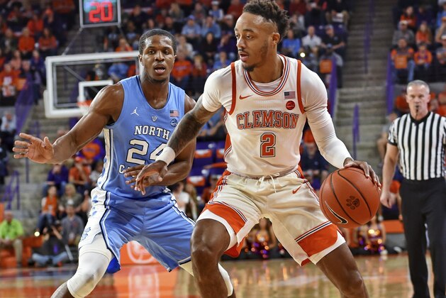 Clemson's Marcquise Reed works the baseline while defended by North Carolina's Kenny Williams during the first half of an NCAA college basketball game Saturday, March 2, 2019, in Clemson, S.C. (AP Photo/Richard Shiro)