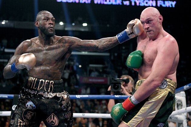 LOS ANGELES, CA - DECEMBER 01:  Deontay Wilder punches Tyson Fury in the ninth round fighting to a draw during the WBC Heavyweight Championship at Staples Center on December 1, 2018 in Los Angeles, California.  (Photo by Harry How/Getty Images)