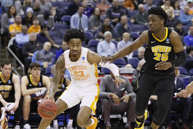 Tennessee's Jordan Bowden (23) drives past Iowa's Tyler Cook (25) in the first half during a second round men's college basketball game in the NCAA Tournament in Columbus, Ohio, Sunday, March 24, 2019. (AP Photo/John Minchillo)