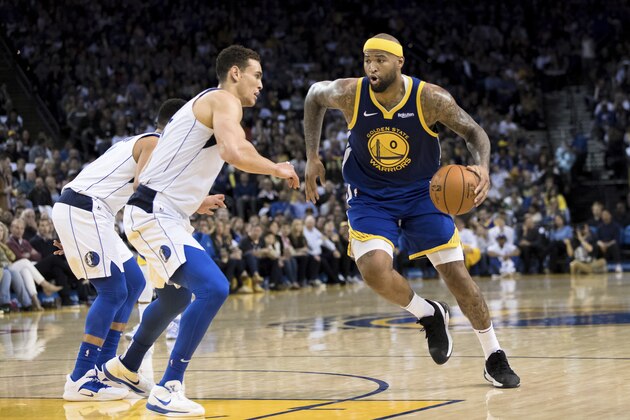 Golden State Warriors center DeMarcus Cousins (0) dibbles as Dallas Mavericks forward Dwight Powell, left, in the second half of an NBA basketball game Saturday, March 23, 2019 in Oakland, Calif. The Mavericks won 126-91. (AP Photo/John Hefti)
