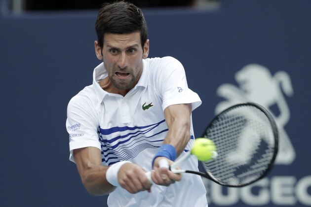 Novak Djokovic, of Serbia, returns to Federico Delbonis, of Argentina, during the Miami Open tennis tournament, Sunday, March 24, 2019, in Miami Gardens, Fla. (AP Photo/Lynne Sladky)