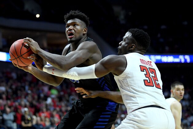 TULSA, OKLAHOMA - MARCH 24:  Nick Perkins #33 of the Buffalo Bulls catches a pass near Norense Odiase #32 of the Texas Tech Red Raiders during the second half of the second round game of the 2019 NCAA Men's Basketball Tournament at BOK Center on March 24, 2019 in Tulsa, Oklahoma. (Photo by Harry How/Getty Images)
