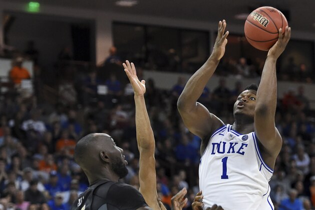 Duke's Zion Williamson shoots over Central Florida's Tacko Fall during the second half of a second-round men's college basketball game in the NCAA Tournament in Columbia, S.C. Sunday, March 24, 2019. (AP Photo/Richard Shiro)