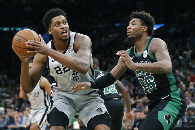 San Antonio Spurs' Rudy Gay (22) looks to shoot against Boston Celtics' Marcus Smart (36) during the second half of an NBA basketball game in Boston, Sunday, March 24, 2019 (AP Photo/Michael Dwyer)