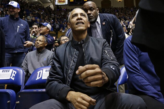 Former President Barack Obama joins fans during an NCAA college basketball game between Duke and North Carolina in Durham, N.C., Wednesday, Feb. 20, 2019. (AP Photo/Gerry Broome)