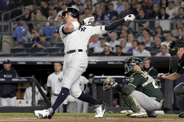New York Yankees' Aaron Judge follows through on a two-run home run against the Oakland Athletics during the first inning of the American League wildcard playoff baseball game, Wednesday, Oct. 3, 2018, in new York (AP Photo/Bill Kostroun)