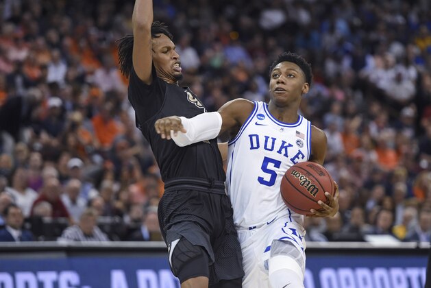 Duke's RJ Barrett (5) drives while defended by Central Florida's Terrell Allen during the second half of a second-round men's college basketball game in the NCAA Tournament in Columbia, S.C., Sunday, March 24, 2019. (AP Photo/Richard Shiro)