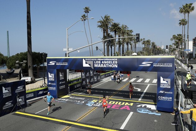 LOS ANGELES, CALIFORNIA - MARCH 24: Runners cross the finish line of the Skechers Performance Los Angeles Marathon on March 24, 2019 in Los Angeles, California. (Photo by Meg Oliphant/Getty Images)