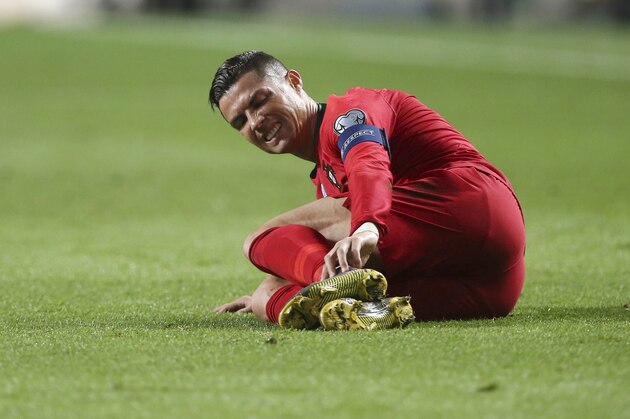 Portugal's Cristiano Ronaldo lies in the pitch during the Euro 2020 group B qualifying soccer match between Portugal and Ukraine at the Luz stadium in Lisbon, Friday, March 22, 2019. (AP Photo/Armando Franca)