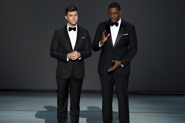 LOS ANGELES, CA - SEPTEMBER 17:  Colin Jost (L) and Michael Che speak onstage during the 70th Emmy Awards at Microsoft Theater on September 17, 2018 in Los Angeles, California.  (Photo by Kevin Winter/Getty Images)