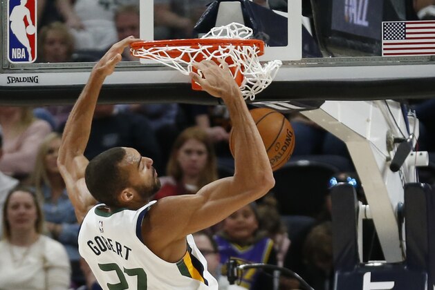 Utah Jazz center Rudy Gobert (27) dunks the ball against the Phoenix Suns during the first half of an NBA basketball game Monday, March 25, 2019, in Salt Lake City. (AP Photo/Rick Bowmer)