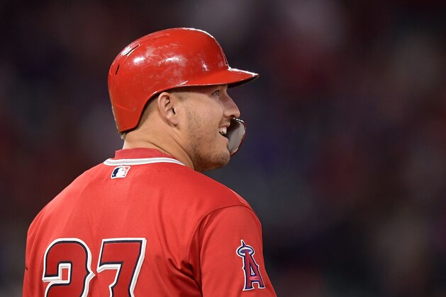 Los Angeles Angels' Mike Trout smiles after hitting a single during the third inning of a preseason baseball game against the Los Angeles Dodgers Monday, March 25, 2019, in Anaheim, Calif. (AP Photo/Mark J. Terrill)
