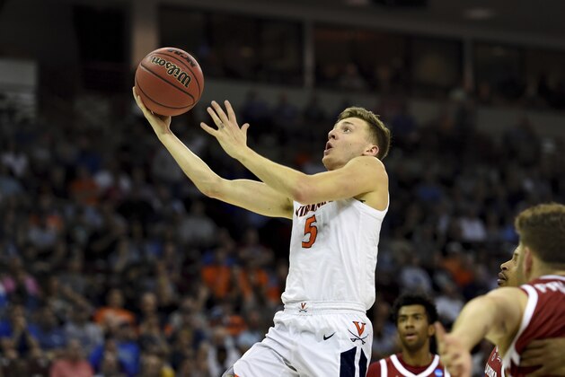 Virginia's Kyle Guy (5) drives for a layup during the second half of a second round men's college basketball game against Oklahoma in the NCAA Tournament in Columbia, S.C. Sunday, March 24, 2019. (AP Photo/Richard Shiro)