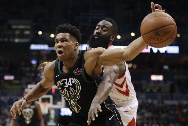 Milwaukee Bucks' Giannis Antetokounmpo is fouled by Houston Rockets' James Harden during the second half of an NBA basketball game Wednesday, March 7, 2018, in Milwaukee. (AP Photo/Morry Gash)
